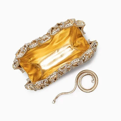 Luna Spark · Clutch con strass y nudo decorativo
