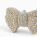 Ora · Clutch con strass y nudo