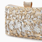 Ema · Clutch con strass y detalle de nudo