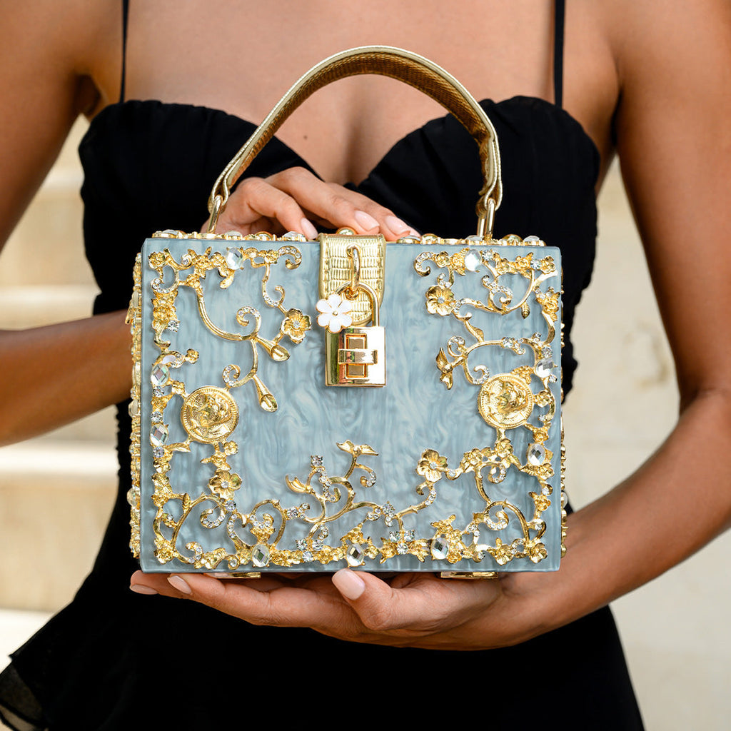 Vittoria · Bolso box de acrílico con detalle floral dorado