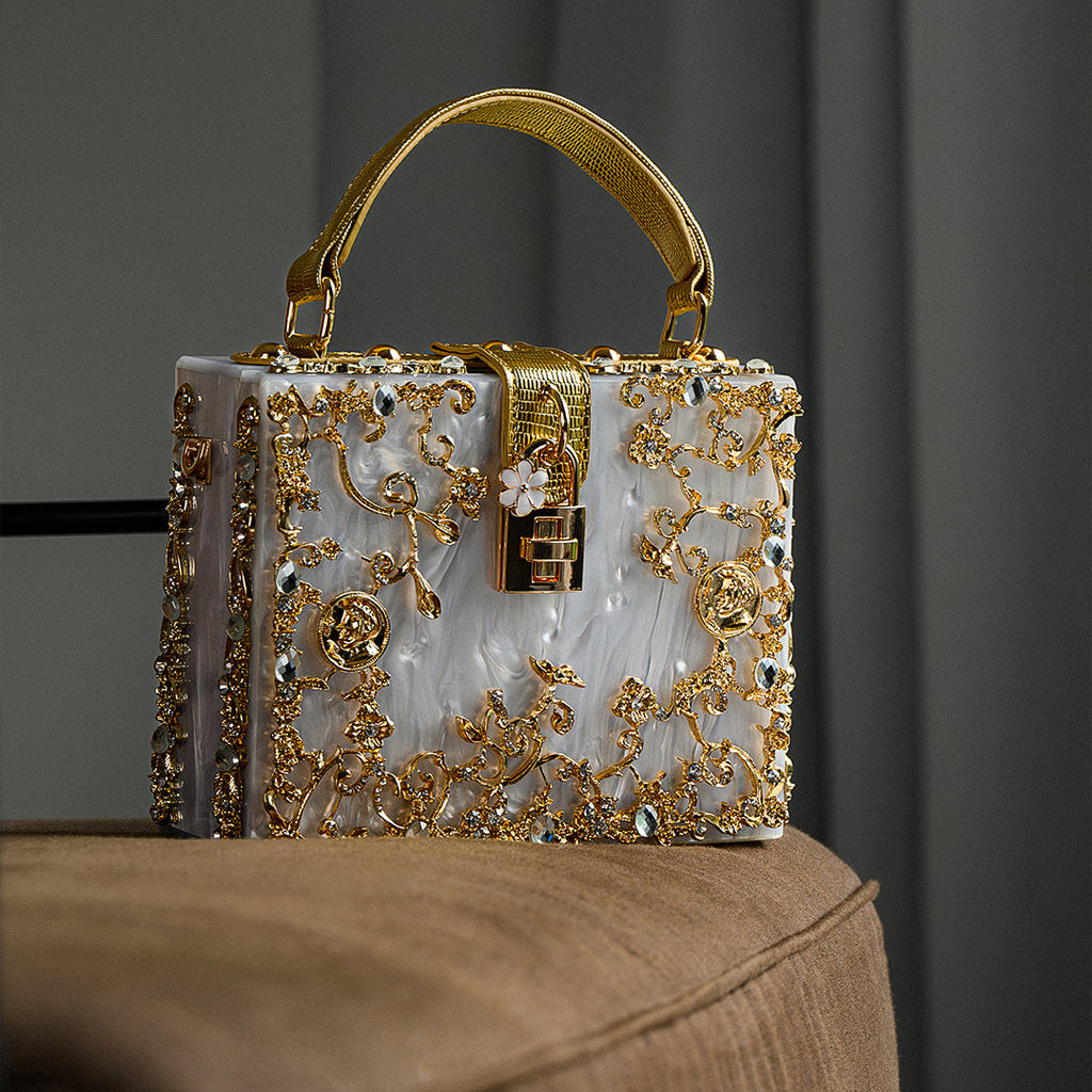 Vittoria · Bolso box de acrílico con detalle floral dorado